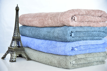 CLOSE UP OF STACKED SOFT AND COLOR COTTON BATH TOWEL. COTTON TOWEL ISOLATED.