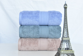 CLOSE UP OF STACKED SOFT AND COLOR COTTON BATH TOWEL. COTTON TOWEL ISOLATED.