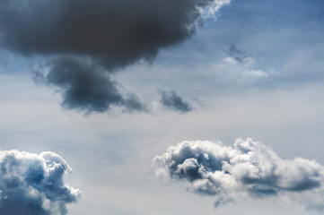 Obraz premium Dark air clouds and clouds in the blue sky