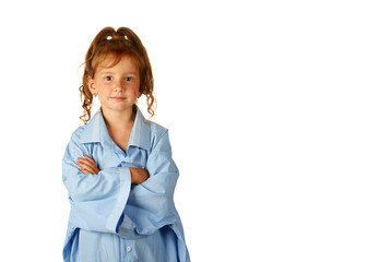 Little girl in father's shirt looks forward thoughtfully, arms crossed over her chest, isolated on...
