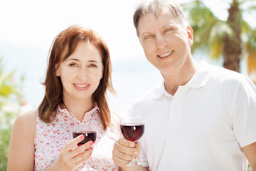 Smiling happy elderly couple in the summer tropical background