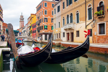 Fototapeta na wymiar Gondolas in Venice canal. Venetian traditional gondola. Venezia cityscape, Italy