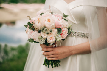 Modern stylish bouquet with a ranunculus and peonies