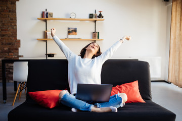 Excited smiling woman celebrating online win, victory, look at screen, using laptop at home,...