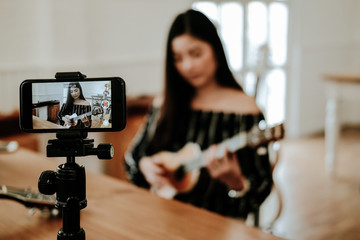 blogger live broadcasting music instrument tutorial on social media. vlogger recording online vlog video.