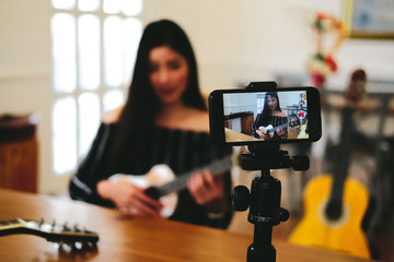 blogger live broadcasting music instrument tutorial on social media. vlogger recording online vlog...