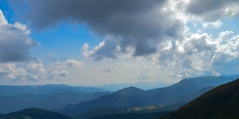 Panoramic view on thunderstorm clouds from Hoverla, Carpathian mountains, Ukraine. Horizontal outdoors shot