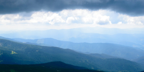 Panoramic view on thunderstorm clouds from Hoverla, Carpathian mountains, Ukraine. Horizontal outdoors shot