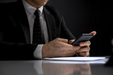 Businessman using his mobile phone making illegal private deal