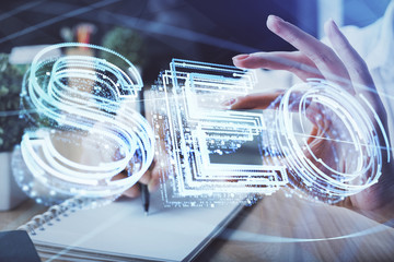 Multi exposure of woman's hands making notes with SEO icon. Concept of Search engine optimization