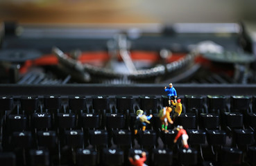 typewriter with the figurines in work