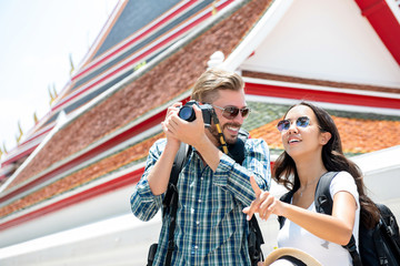 Interracial tourist couple enjoying their amazing tour around bangkok thailand