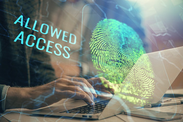 Fingerprint hologram with businessman working on computer on background. Security concept. Double...