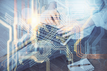 Double exposure of world map hologram with man working on computer on background. Concept of worldwideweb.