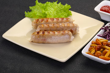 Grilled sausages served mushrooms and cabbage