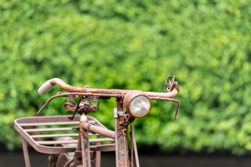 Vintage antique bicycle in the green park. Rust retro vintage bicycle style for aged and old decoration.
