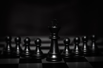 King chess piece stand in front of pawn (Concept of leadership, management)