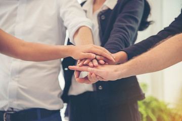 Group of diversity people with success partnership fist bump of hands together to show power and unified teams in office. Business teamwork trust in partner. Teamwork Concept.