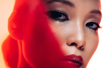 perfect asian woman with makeup in red light