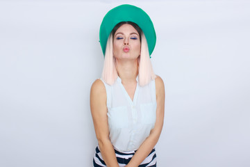 Beautiful blonde woman in green hat