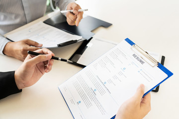 Job Interview and hiring concept, Appointment candidate Business man explaining about his profile and answer to Human resources manager sitting at a table opposite in the office
