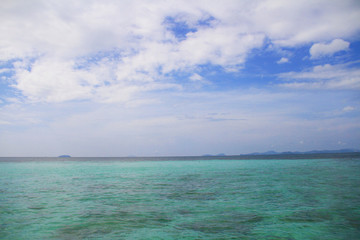 Emerald sea with blue sky and cloud on a good day.