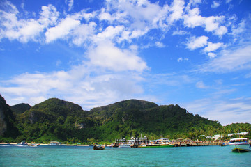 Seascape and the coast with the boat parked. Blue sky and cloud, very happy every time when seeing.