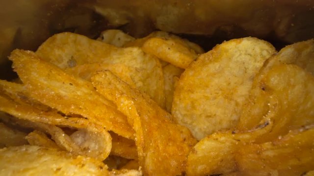 Inside the potato chips bag. Opened pack of original taste delicious potato crisps. Fast food and unhealthy eating concept