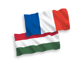 National vector fabric wave flags of France and Hungary isolated on white background. 1 to 2 proportion.