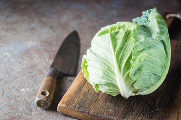 Fresh green garden cabbage on rustic stone background
