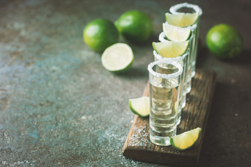 Mexican Gold Tequila with lime and salt on black background with copyspace.