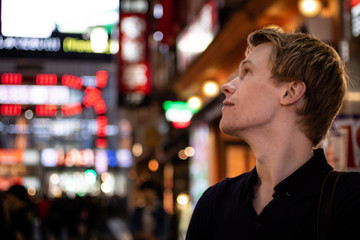 A handsome blond tourist looking of to the side