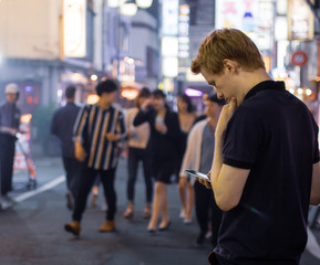 A handsome man looking at his phone