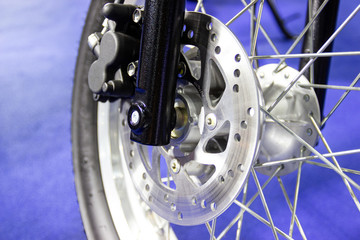 close up - wheel spokes and brake disc of a motorcycle