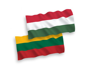 National vector fabric wave flags of Lithuania and Hungary isolated on white background. 1 to 2 proportion.
