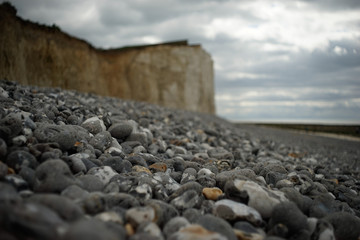 stones on the beach by a cliff