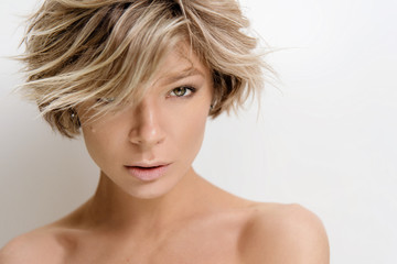 Beautiful young woman model with light color hair. Beauty portrait with clean skin and nude makeup....