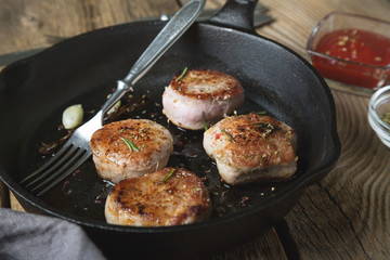 Fried pork tenderloin medallions with spices and herbs