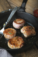 Fried pork tenderloin medallions with spices and herbs