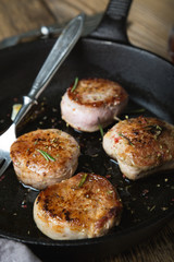 Fried pork tenderloin medallions with spices and herbs