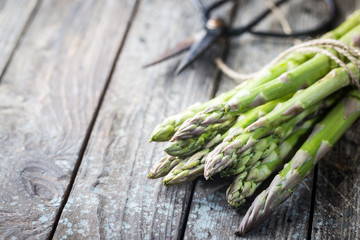 Bunch of fresh asparagus on wooden table