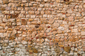 Stone wall of the medieval fortress, Stone background pattern