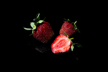 juicy strawberries on a dark background