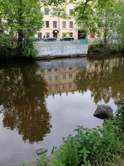 reflection of houses and trees on the river in St. Petersburg 