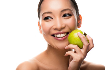 smiling asian woman holding fresh green apple, isolated on white