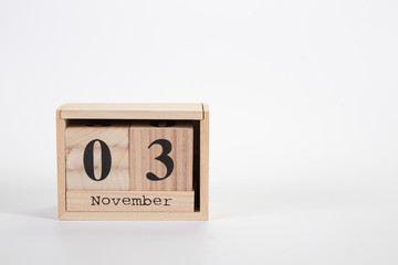 Wooden calendar November 03 on a white background