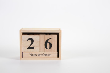 Wooden calendar November 26 on a white background
