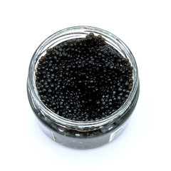 Open glass jar of black caviar on isolated white background. A delicacy made from the eggs of sturgeon. Luxury food from Volga in Russia. Top view of the jar with black caviar Beluga.