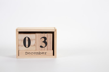 Wooden calendar December 03 on a white background