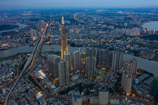 Top View of Building in a City - Aerial view Skyscrapers flying by drone of Ho Chi Mi City with development buildings, transportation, energy power infrastructure.